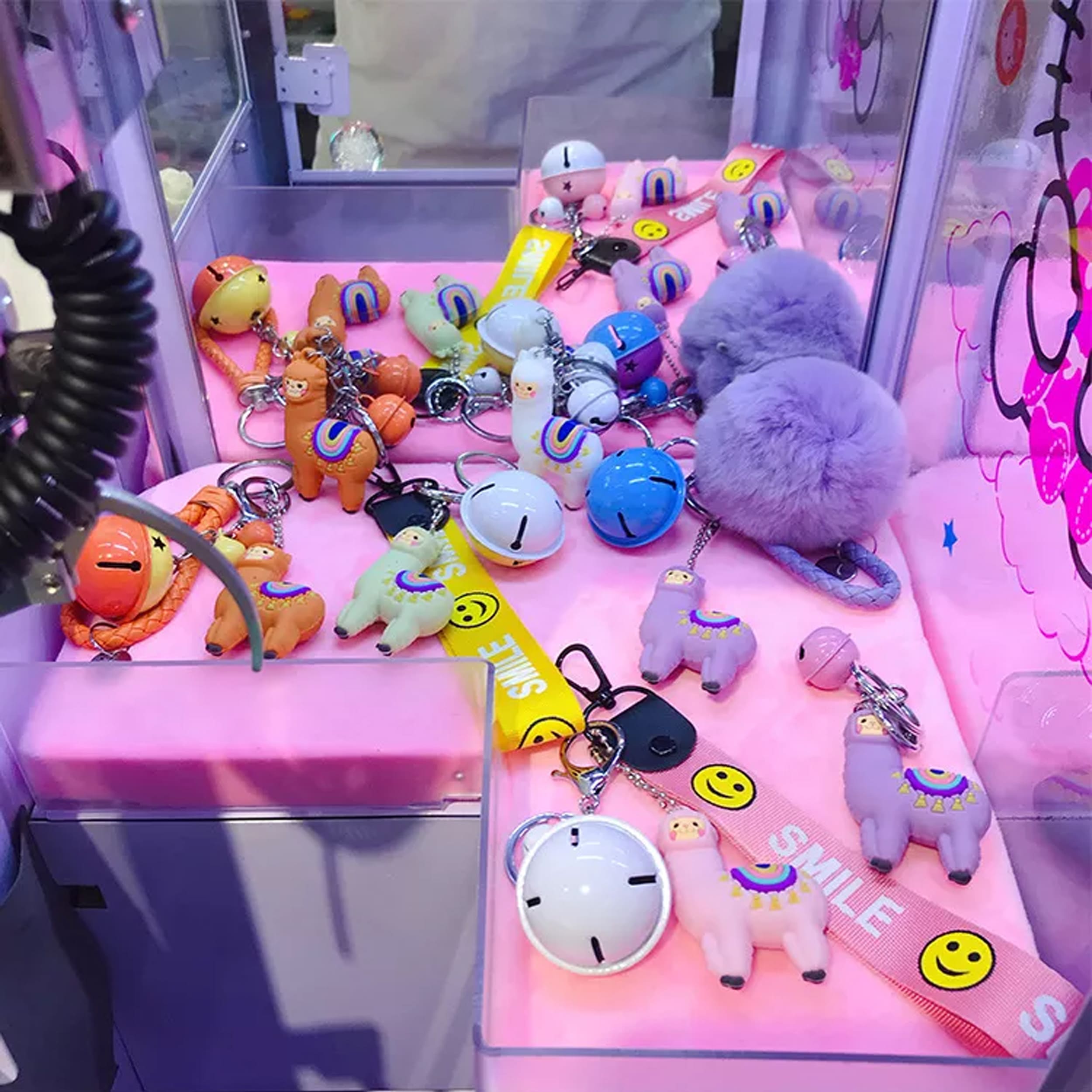 Multiple Lama keychain with bell on pink table