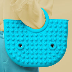 blue pop it fidget handbag in hands of a model wearing yellow top